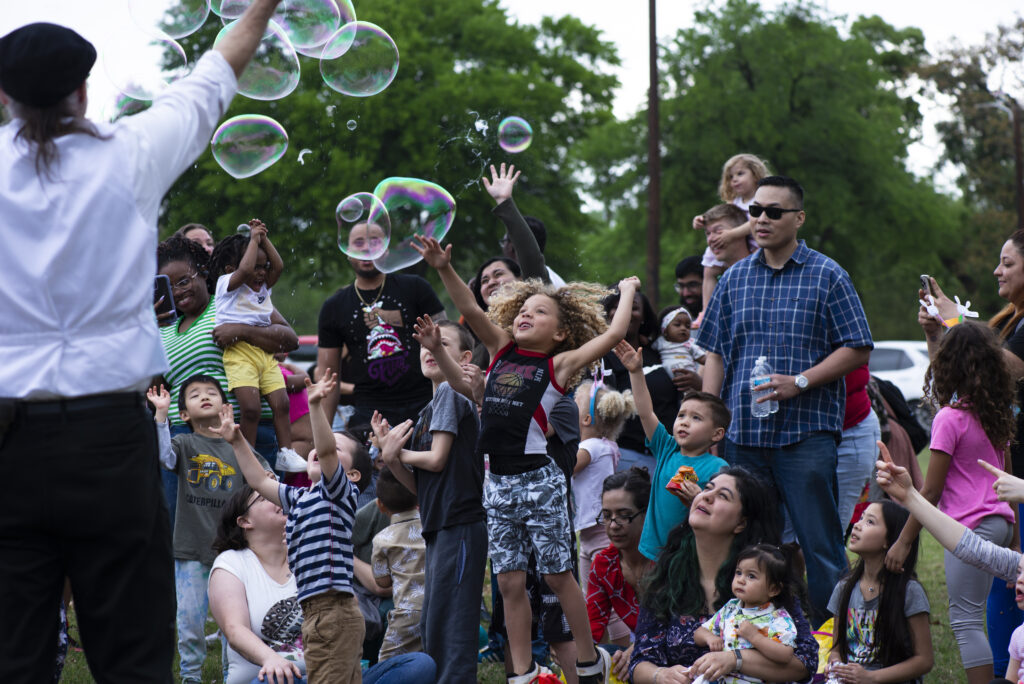 Bubble show with children and parents watching and playing